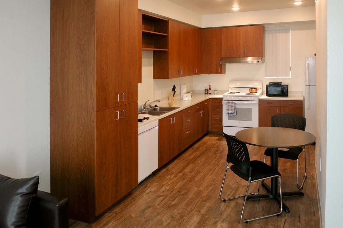 a kitchen with a table and chairs and a stove.