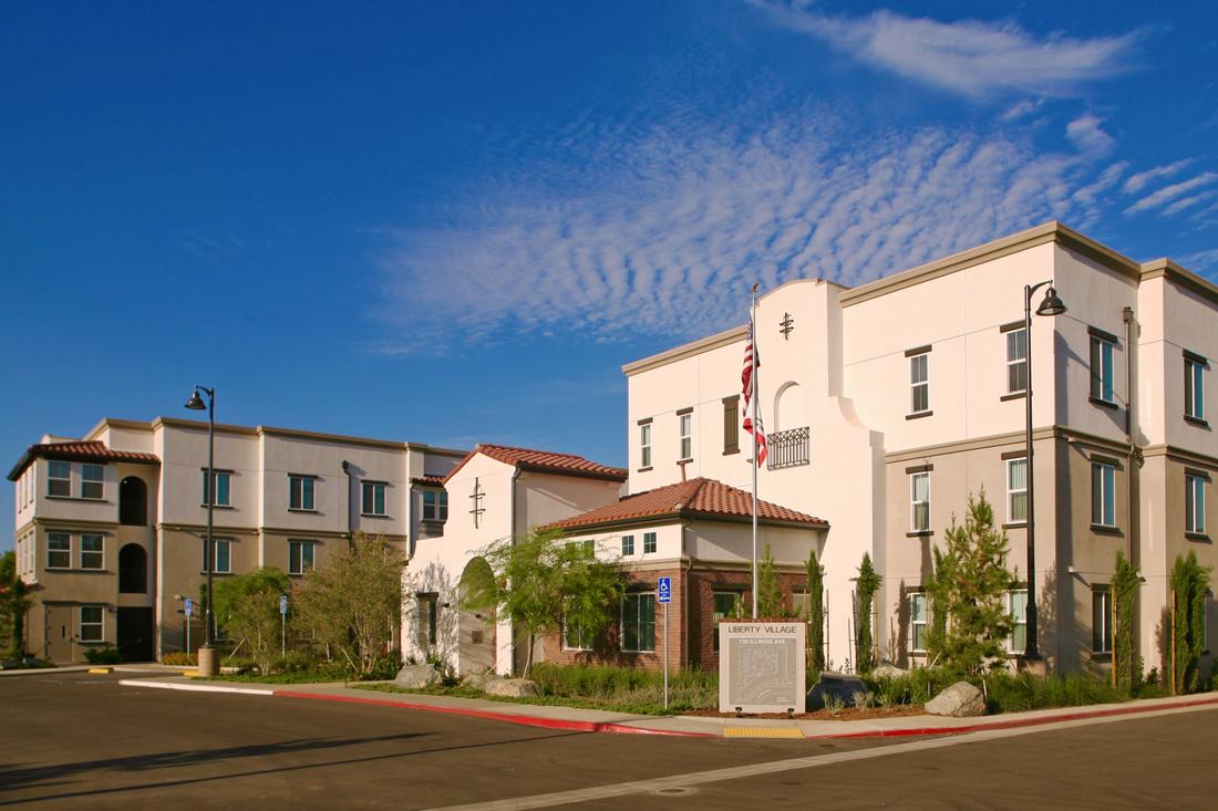 a row of white buildings with a blue sky in the background.
