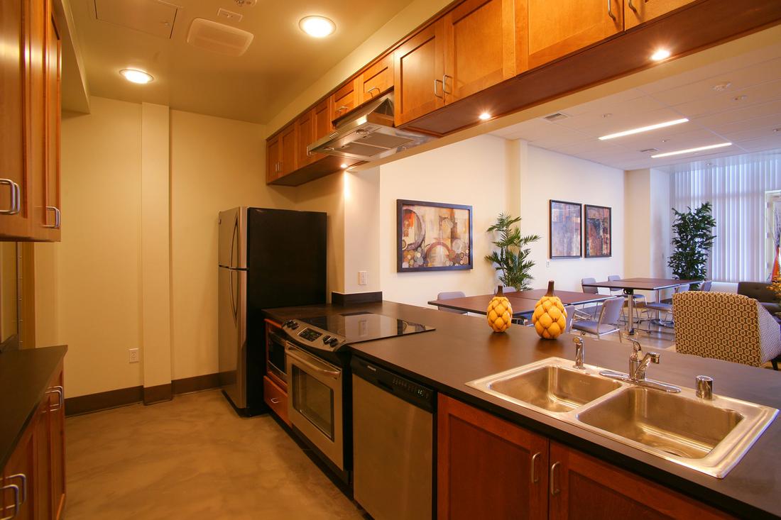a kitchen with a sink, stove and refrigerator.