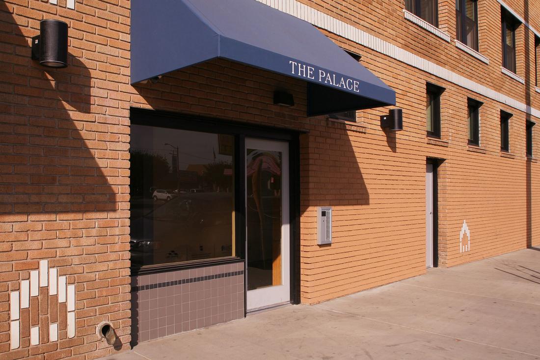 a brick building with a large blue awning.