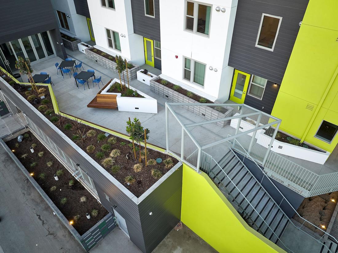 an aerial view of a building with a green roof.