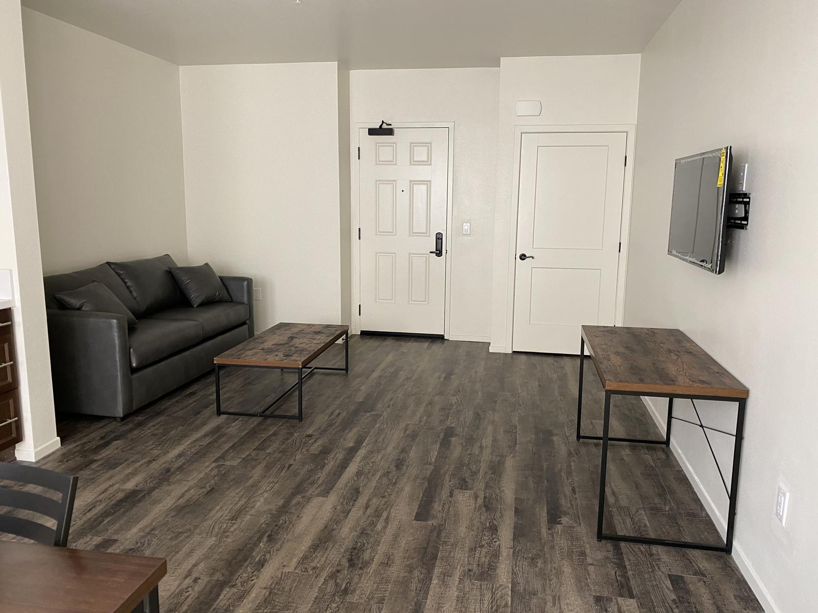 a living room filled with furniture and a flat screen tv.