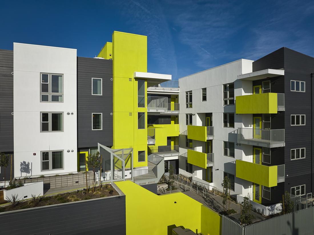 a row of multi - story buildings with balconies and balconies on.