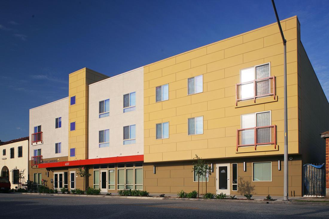 a yellow building with red trim on the side of it.