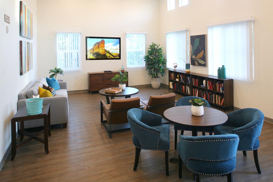 a living room filled with furniture and a flat screen tv.