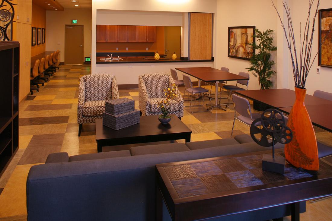 a living room filled with furniture and a large window.