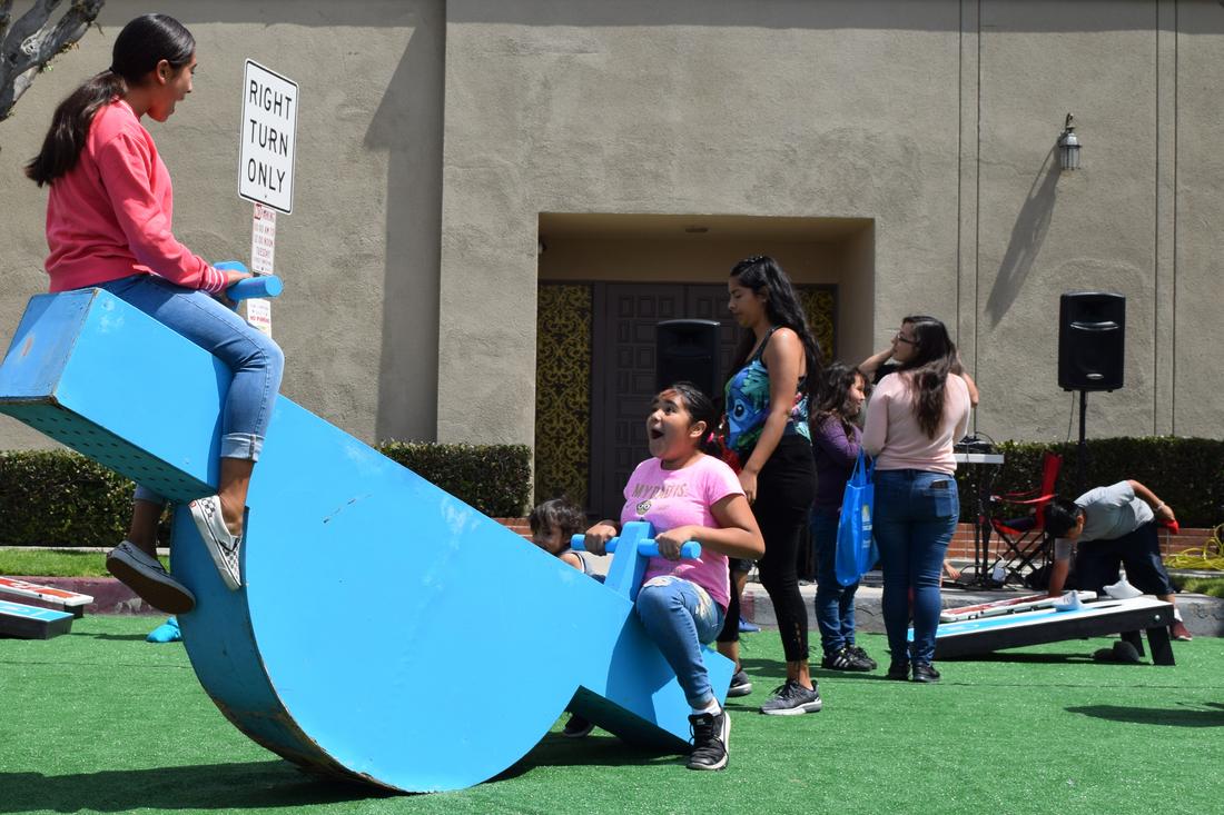 a group of people standing around a playground.