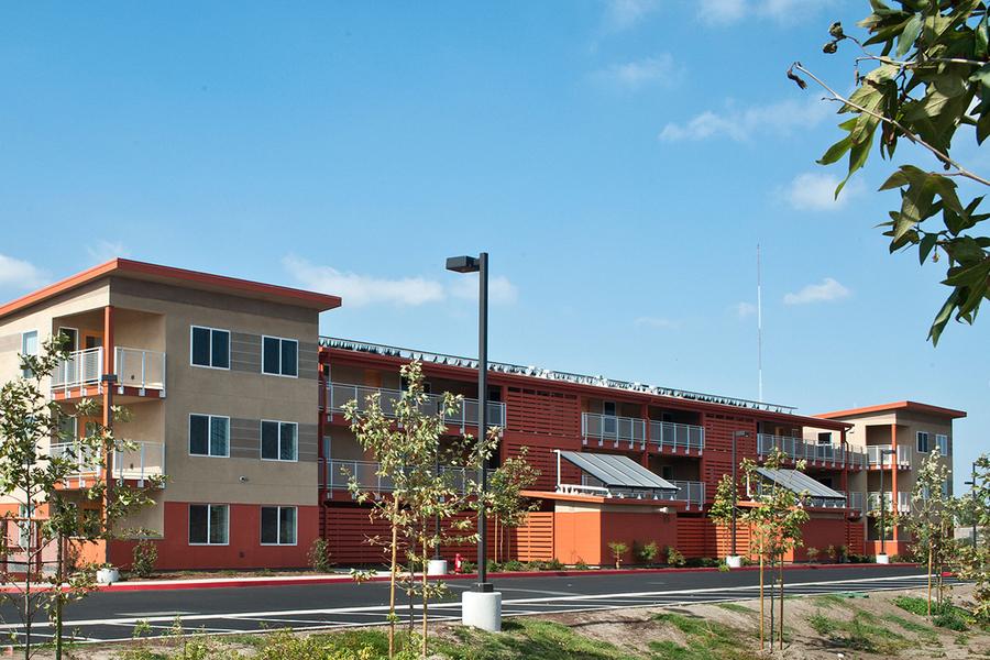 a red and tan building with a street light in front of it.