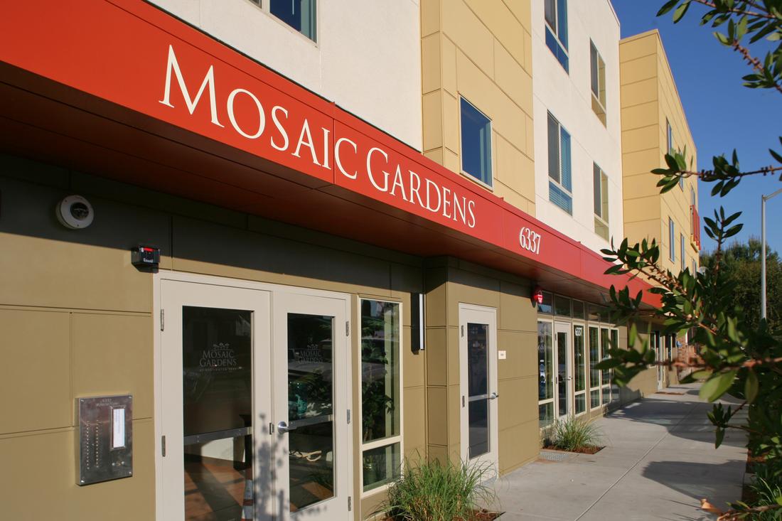 a building with a sign that says mosaic gardens.